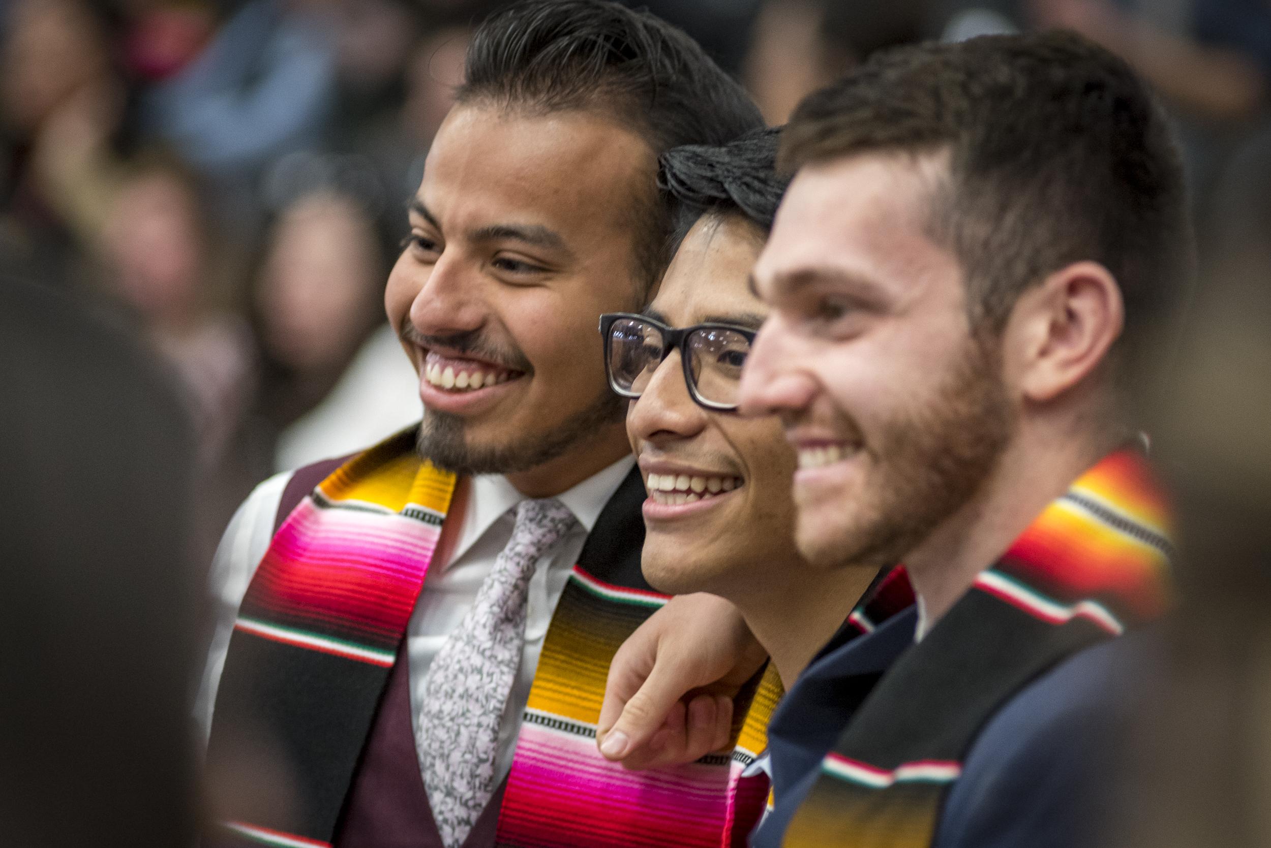 Three graduates smiling at the 密歇根州立大学丹佛 Latinx Graduation Spring 2019